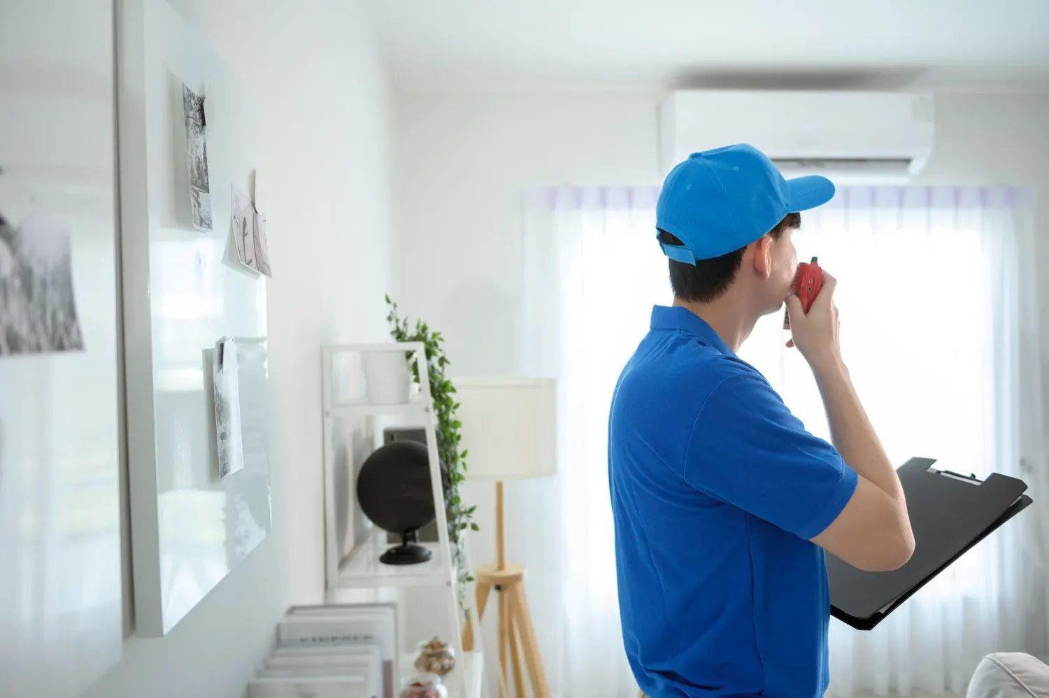 HVAC technician reviewing a job checklist in a home